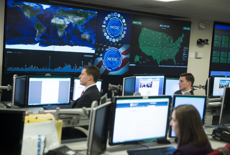 Staff members sit at their work stations at the National Cybersecurity and Communications Integration Center in Arlington, Virginia, January 13, 2015. US President Barack Obama visited the facility to talk about cyber security. AFP PHOTO / SAUL LOEB