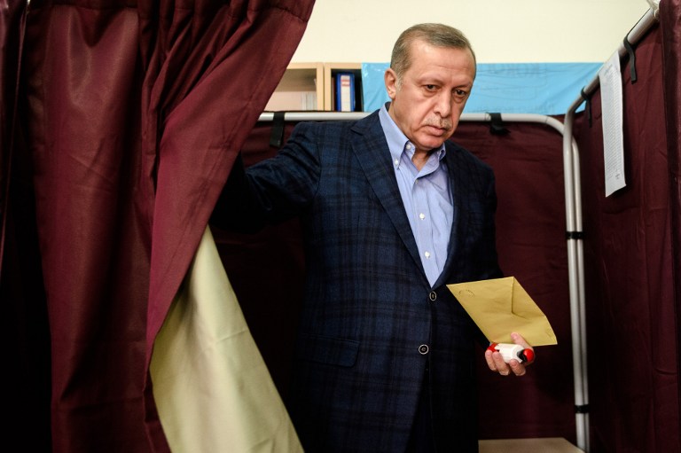 TOPSHOTS Turkish President Recep Tayyip Erdogan exits a voting booth at a polling station in Istanbul on November 1, 2015. Turkey voted November 1 in one of its most crucial elections in years, with the country deeply divided in the face of surging Kurdish and Islamic violence and concerns about democracy and the economy. The poll is the second in just five months, called after President Recep Tayyip Erdogan's Justice and Development Party (AKP) was stripped of its parliamentary majority in June for the first time in 13 years and then failed to forge a coalition government. AFP PHOTO / OZAN KOSE