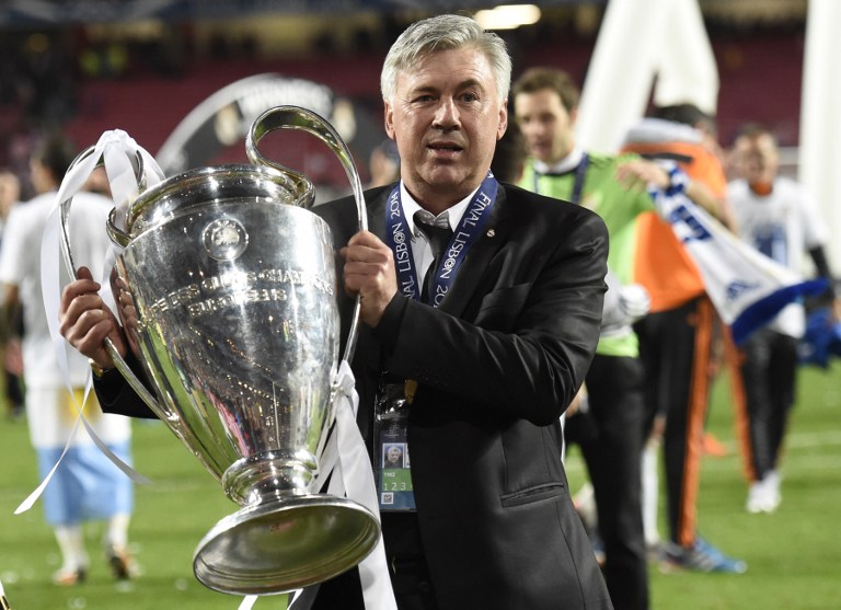 Real Madrid's Italian coach Carlo Ancelotti poses with the trophy at the end of the UEFA Champions League Final Real Madrid vs Atletico de Madrid at Luz stadium in Lisbon, on May 24, 2014. Real Madrid won 4-1. AFP PHOTO/ FRANCK FIFE