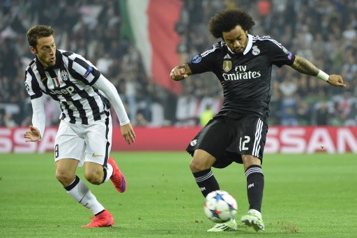 Real Madrid's Brazilian defender Marcelo (R) vies with Juventus' midfielder Claudio Marchisio during the UEFA Champions League semi-final first leg football match Juventus vs Real Madrid on May 5, 2015 at the Juventus stadium in Turin.       AFP PHOTO / OLIVIER MORIN
