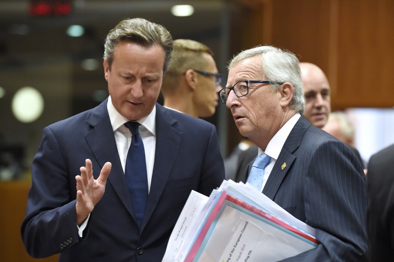 British Prime Minister David Cameron (L) speaks with European Commission president-elect Jean-Claude Juncker during an EU summit at the EU headquarters in Brussels on August 30, 2014. European leaders are set to fill two of the top jobs in Brussels, with Polish premier and Kremlin critic Donald Tusk favourite to become EU president amid deepening tensions with Russia. AFP PHOTO/JOHN THYS