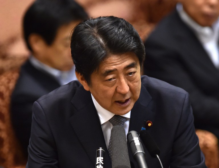 Japanese Prime Minister Shinzo Abe answers a question by an opposition lawmaker at the Upper House's budget committee session at the National Diet in Tokyo on August 24, 2015. Abe will not visit China next month as he faces parliamentary backlash over his bid to expand the role of the military. Earlier this month, Abe repeated a desire to meet Chinese President Xi Jinping in early September, but was not expected to attend a huge Beijing military show of strength to commemorate the 70th anniversary of Japan's defeat in World War II.  AFP PHOTO / Yoshikazu TSUNO