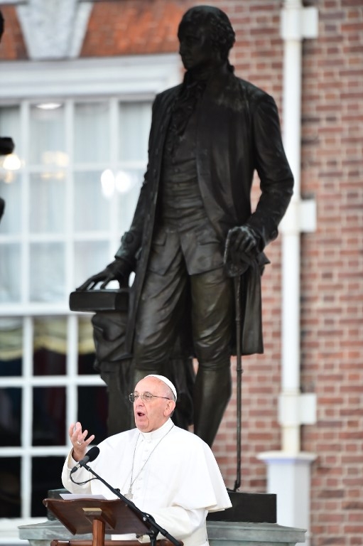 Pope Francis speaks beneath a statue of the first US President George Washington at Independence Hall in Philadelphia on September 26, 2015. AFP PHOTO / VINCENZO PINTO