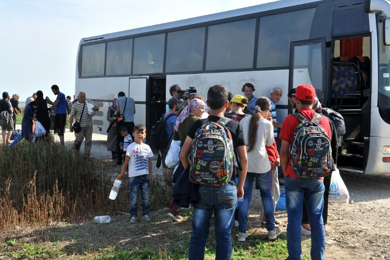 Migrant women from Middle Eastern countries disembark near the village of Tovarnik, near the official border crossing between Serbia and Croatia on September 16, 2015. Migrants began to cross from Serbia into Croatia on September 16, desperate to find a new way into the European Union after Hungary sealed its border and a string of EU countries tightened frontier controls in the face of an unprecedented human influx. AFP PHOTO / ELVIS BARUKCIC
