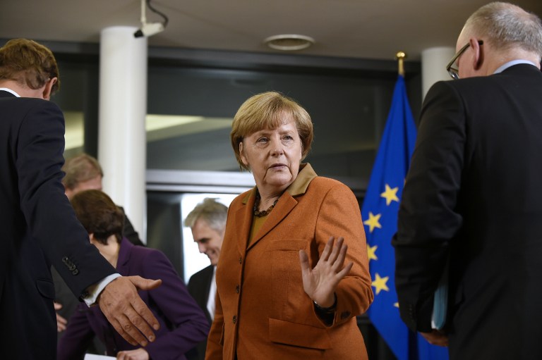 German Chancellor Angela Merkel gestures as she arrives to pose for a family picture during the EU-Balkans mini summit at the EU headquarters in Brussels. European Union and Balkan leaders met to tackle the migrant crisis as Slovenia warned the bloc will "start falling apart" if it fails to take concrete action within weeks. AFP PHOTO / JOHN THYS
