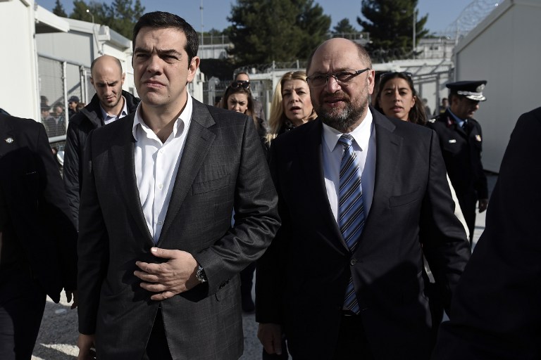 Greek Prime Minister Alexis Tsipras (L) and European parliament President Martin Schulz visit the Moria Hot Spot in Mytilene on November 5, 2015. Since the start of the summer, the Greek island of Lesbos has assumed notoriety as the main gateway into Europe for thousands of desperate refugees. AFP PHOTO / ARIS MESSINIS