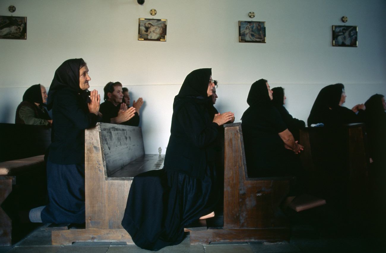 Mourners pray during the funeral of a Croat woman killed in the battles against Serbs during the Yugoslavian Civil War in the small Croatian village of Novi Mikanovci, located 50km from Vukovar., Image: 15113462, License: Rights-managed, Restrictions: Content available for editorial use, pre-approval required for all other uses. This content may not be materially modified or used in composite content., Model Release: no, Credit line: Profimedia, Corbis