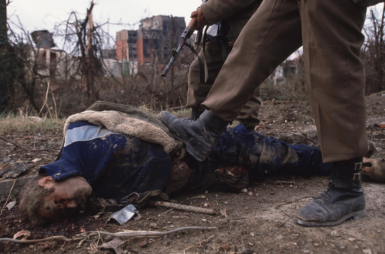 Ethnic Cleansing - Serbian soldiers and one of their victims after the fall...