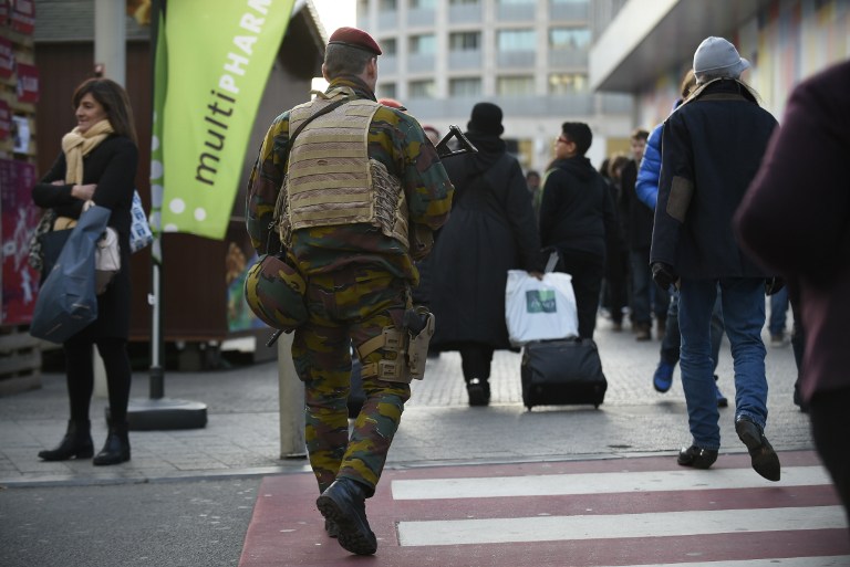 Soldiers patrol in Brussels, on December 31, 2015. Battling terror on two fronts, Belgian police were holding eight people Thursday over an alleged New Year plot in Brussels and also arrested a tenth suspect over last month's massacre in Paris. Both Brussels and Paris have cancelled annual New Year's Eve fireworks displays as soldiers and police ramped up security in European capitals over perceived terror threats. / AFP / JOHN THYS