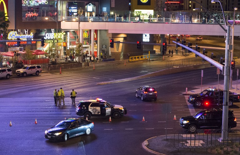 Police and local officials investigate a part of the Las Vegas Strip after a car ran into a group of pedestrians between Planet Hollywood, where the Miss Universe pageant took place, and the Paris Las Vegas Hotel in Las Vegas, Nevada, on December 20, 2015. At least one person has died and more than 37 have been hurt after a car ran into a group of pedestrians on the bustling Las Vegas Strip on December 20, police said, adding the driver was in custody. AFP PHOTO / VALERIE MACON / AFP / VALERIE MACON