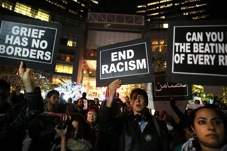 NEW YORK, NY - DECEMBER 10: People listen to speakers at a demonstration against racism and conservative presidential candidate Donald Trump's recent remarks concerning Muslims on December 10, 2015 in New York City. Dozens or demonstrators and activists converged at Columbus Circle to denounce the politics of Trump and the treatment of Muslim refugees both in America and Europe. Spencer Platt/Getty Images/AFP