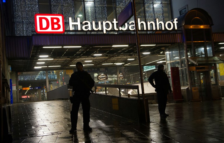 Police stands guard outside the Munich train station on December 31, 2015 in German police said Thursday that they had "indications that a terror attack" was being planned for New Year's Eve in the southern city of Munich, as they called on the public to avoid large gatherings and two key train stations. / AFP / dpa / Sven Hoppe / Germany OUT
