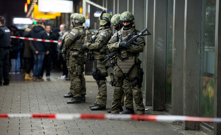 Police is pictured outside the Munich train station on December 31, 2015. German police said Thursday that they had "indications that a terror attack" was being planned for New Year's Eve in the southern city of Munich, as they called on the public to avoid large gatherings and two key train stations. / AFP / dpa / Sven Hoppe / Germany OUT