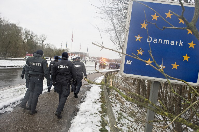 (FILES) This file photo taken on January 09, 2016 shows Danish police officers walking at the Danish-German border on January 9, 2016 in Krusaa, Denmark. A controversial bill is due to be discussed in the Danish parliament on Wednesday, January 13, 2016, which would allow police to seize migrants' valuables to pay for their stay in asylum centres. / AFP / Scanpix Denmark / Claus Fisker