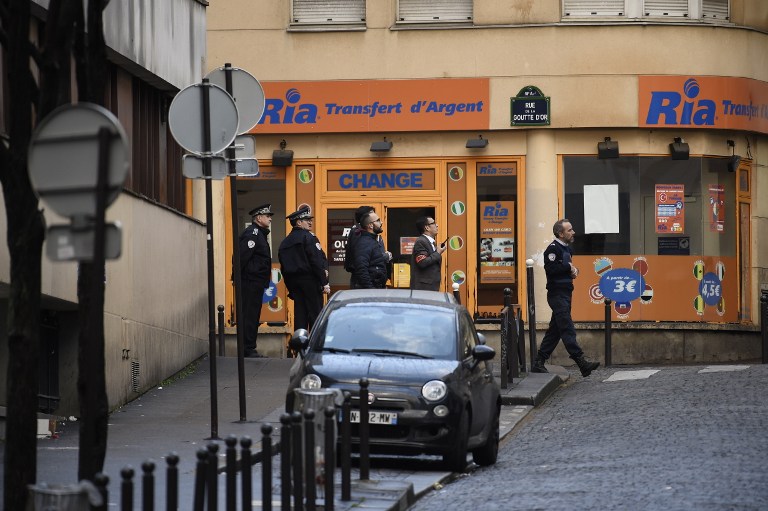 French police are seen near a police station in the Rue de la Goutte d'Or near Barbes-Rochechouart metro station in the north of Paris on January 7, 2016, after police shot a man dead as he was trying to enter the police station. A witness told AFP he had heard "two or three shots" in the incident that occurred a year to the day of the jihadist attack on satirical newspaper Charlie Hebdo. AFP PHOTO / LIONEL BONAVENTURE / AFP / LIONEL BONAVENTURE