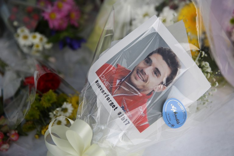 Tributes to late Marussia driver Jules Bianchi of France are placed at a stand near a section of the track where the accident occurred last year, during the Formula One Japanese Grand Prix in Suzuka on September 26, 2015.  AFP PHOTO/YURIKO NAKAO  / AFP / YURIKO NAKAO