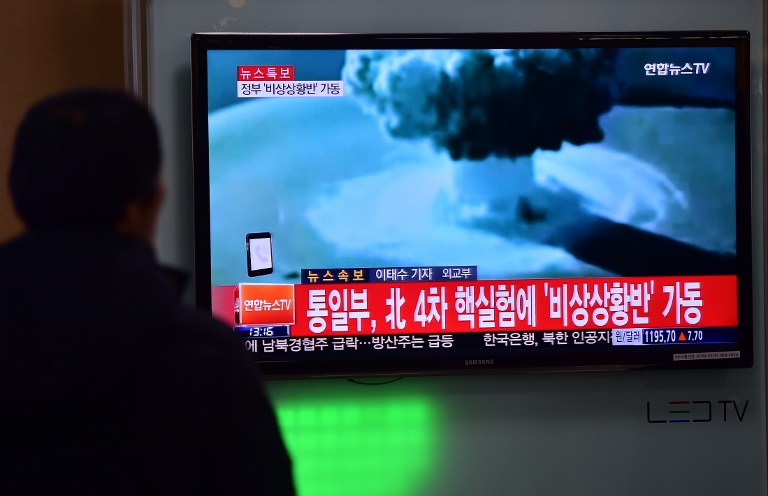 ADDITION- People watch a news report on North Korea's first hydrogen bomb test at a railroad station in Seoul on January 6, 2016. South Korea "strongly" condemned North Korea's shock hydrogen bomb test and vowed to take "all necessary measures" to penalise its nuclear-armed neighbour.  The image shown on TV shows files images from other nuclear tests from other countries and the caption in red at the bottom of the screen reads "the Blue House will convene an emergency meeting of the NSC, the National Security Council."   AFP PHOTO / JUNG YEON-JE / AFP / JUNG YEON-JE