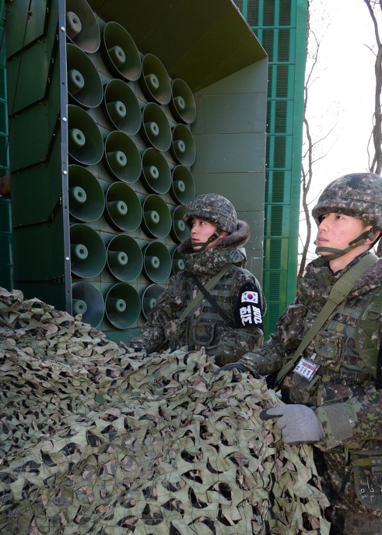 South Korean soldiers remove a camouflage net from loudspeakers as the military prepares propaganda broadcasts near the border area between South Korea and North Korea in Yeoncheon, northeast of Seoul, on January 8, 2016. South Korea on January 8 resumed high-decibel propaganda broadcasts into North Korea as the United States ramped up pressure on China to bring Pyongyang to heel after its latest nuclear test. REPUBLIC OF KOREA OUT NO ARCHIVES RESTRICTED TO SUBSCRIPTION USE AFP PHOTO / YONHAP / AFP / YONHAP / YONHAP