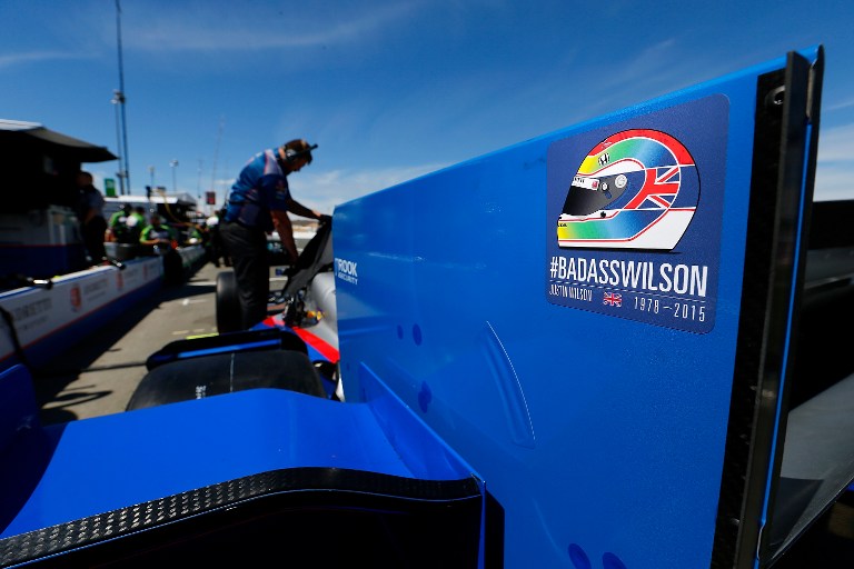 SONOMA, CA - AUGUST 28: Tributes to English driver Justin Wilson are displyed on cars during practice for the Verizon IndyCar Series GoPro Grand Prix of Sonaom at Sonoma Raceway on August 28, 2015 in Sonoma, California. Wilson died of injuries last week after a crash at Pocono Raceway.   Jonathan Ferrey/Getty Images/AFP