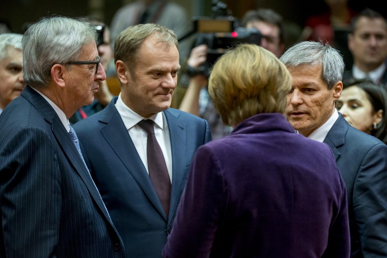 German Chancellor Angela Merkel (2ndR) speak with Austria's Chancellor Werner Faymann (R) as European Commission president Jean-Claude Juncker (L) and European council president Donald Tusk (2ndL) look on as part of the final European Union (EU) summit of the year at the European Council in Brussels on December 17, 2015. EU leaders will discuss British Prime Minister David Cameron's controversial reform demands as well as plans for a new European border force to deal with the migration crisis. / AFP / BELGA / Danny Gys