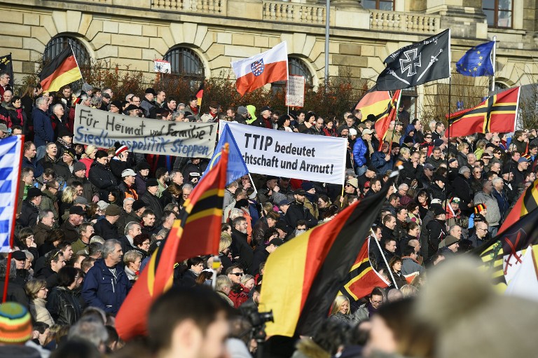 Supporters of the Pegida movement (Patriotic Europeans Against the Islamisation of the Occident) gather in Dresden, eastern Germany, on February 6, 2016. / AFP / TOBIAS SCHWARZ