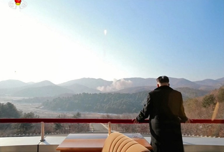 This picture taken from North Korean TV and released by South Korean news agency Yonhap on February 7, 2016 shows North Korean leader Kim Jong-Un (C) looking at the rocket launch of earth observation satellite Kwangmyong 4. North Korea said on February 7, it had successfully put a satellite into orbit, with a rocket launch widely condemned as a ballistic missile test for a weapons delivery system to strike the US mainland. REPUBLIC OF KOREA OUT -- RESTRICTED TO SUBSCRIPTION USE -- AFP PHOTO / North Korean TV via YONHAP -- NO MARKETING - NO ADVERTISING CAMPAIGNS - DISTRIBUTED AS A SERVICE TO CLIENTS -- THIS PICTURE WAS MADE AVAILABLE BY A THIRD PARTY. AFP CAN NOT INDEPENDENTLY VERIFY THE AUTHENTICITY, LOCATION, DATE AND CONTENT OF THIS IMAGE. THIS PHOTO IS DISTRIBUTED EXACTLY AS RECEIVED BY AFP. / AFP / NORTH KOREAN TV / YONHAP