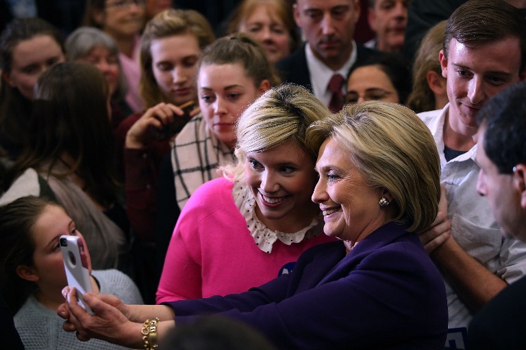 HAMPTON, NH - FEBRUARY 02: Democratic presidential candidate former Secretary of State Hillary Clinton takes a selfie with a supporter during a "get out the vote" event at Winnacunnet High School on February 2, 2016 in Hampton, New Hampshire. A day after narrowly defeating democratic candidate Sen. Bernie Sanders (I-VT), Hillary Clinton is campaigning in New Hampshire a week ahead of the state's primary. Justin Sullivan/Getty Images/AFP