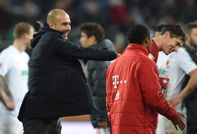 (L-R) Bayern Munich's Spanish headcoach Pep Guardiola jokes with Bayern Munich's Brazilian midfielder Douglas Costa and Bayern Munich's Polish striker Robert Lewandowski after the German first division Bundesliga football match of FC Augsburg vs FC Bayern Munich in Augsburg, southern Germany, on February 14, 2016. / AFP / CHRISTOF STACHE / RESTRICTIONS: DURING MATCH TIME: DFL RULES TO LIMIT THE ONLINE USAGE TO 15 PICTURES PER MATCH AND FORBID IMAGE SEQUENCES TO SIMULATE VIDEO. == RESTRICTED TO EDITORIAL USE == FOR FURTHER QUERIES PLEASE CONTACT DFL DIRECTLY AT + 49 69 650050