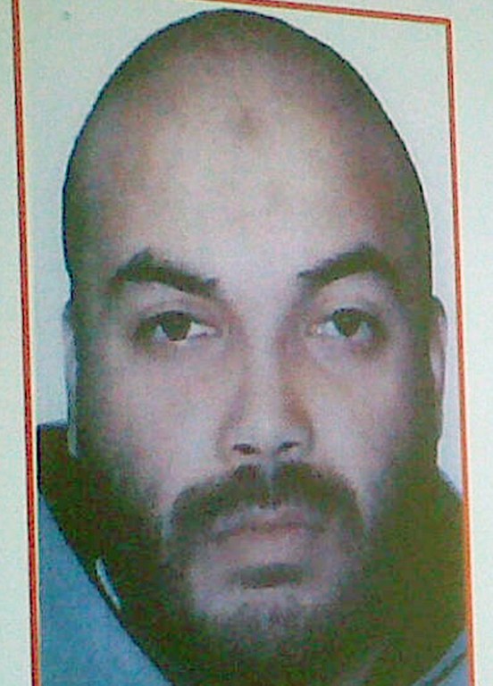 A portrait of a Salafist extremist, Boubaker Hakim is displayed on a giant screen during a press conference of Tunisian Interior Minister in Tunis on July 26, 2013. "The first elements of the investigation show the implication of Boubaker Hakim" in Brahmi's killing the minister said. The 30-year-old Paris-born suspect was already wanted in Tunisia for kidnapping and arms trafficking. AFP PHOTO / STR / AFP / -