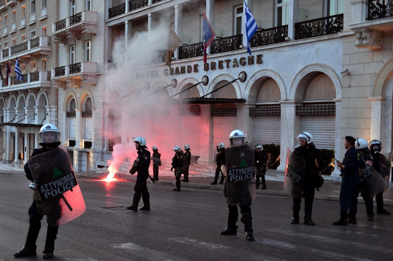 Greek police stand guard during a protest rally against the latest reform measures demanded by Greece's creditors, in front of the Greek parliament building in Athens on May 8, 2016. The reforms to be voted on by MPs later on May 8 would reduce Greece's highest pension payouts, merge several pension funds, increase contributions and raise taxes for those on medium and high incomes. / AFP PHOTO / LOUISA GOULIAMAKI