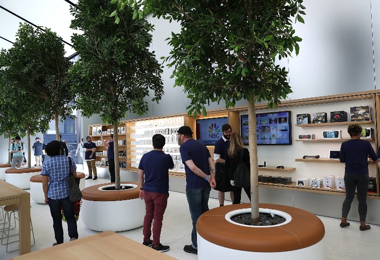SAN FRANCISCO, CA - MAY 19: Members of media tour the "Genius Grove" during a press preview of the new flagship Apple Store on May 19, 2016 in San Francisco, California. Apple is preparing to open its newest flagship store in San Francisco's Union Square on Saturday May 21. The new store features new design elements as well as community programs including the "genius grove" where where customers can get support under a canopy of local trees and "the plaza" a public space that will be open 24 hour a day. Visitors will enter the store through 42-foot tall sliding glass doors. Justin Sullivan/Getty Images/AFP