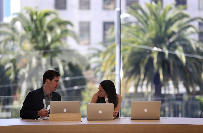 SAN FRANCISCO, CA - MAY 19: Apple employees work on laptops in "The Forum" inside the new flagship Apple Store on May 19, 2016 in San Francisco, California. Apple is preparing to open its newest flagship store in San Francisco's Union Square on Saturday May 21. The new store features new design elements as well as community programs including the "genius grove" where where customers can get support under a canopy of local trees and "the plaza" a public space that will be open 24 hour a day. Visitors will enter the store through 42-foot tall sliding glass doors. Justin Sullivan/Getty Images/AFP