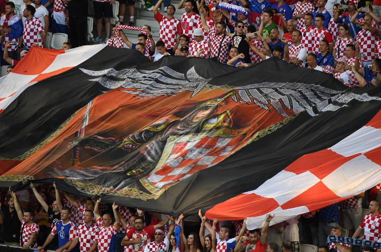 Croatia supporters wave a giant flag during the Euro 2016 group D football match between Croatia and Spain at the Matmut Atlantique stadium in Bordeaux on June 21, 2016. / AFP PHOTO / MEHDI FEDOUACH