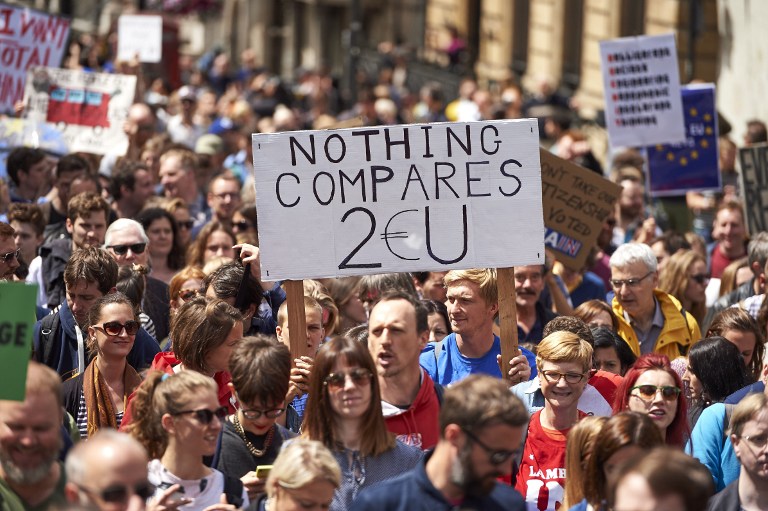People hold up pro-Europe placards as thousands of protesters take part in a March for Europe, through the centre of London on July 2, 2016, to protest against Britain's vote to leave the EU, which has plunged the government into political turmoil and left the country deeply polarised. Protesters from a variety of movements march from Park Lane to Parliament Square to show solidarity with those looking to create a more positive, inclusive kinder Britain in Europe. / AFP PHOTO / Niklas HALLE'N
