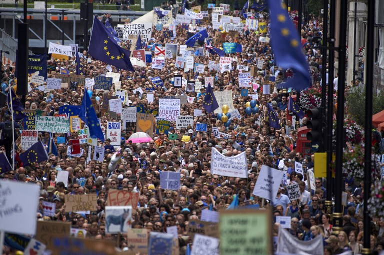 People hold up pro-Europe placards and European flags as thousands of protesters take part in a March for Europe, through the centre of London on July 2, 2016, to protest against Britain's vote to leave the EU, which has plunged the government into political turmoil and left the country deeply polarised. Protesters from a variety of movements march from Park Lane to Parliament Square to show solidarity with those looking to create a more positive, inclusive kinder Britain in Europe. / AFP PHOTO / Niklas HALLE'N