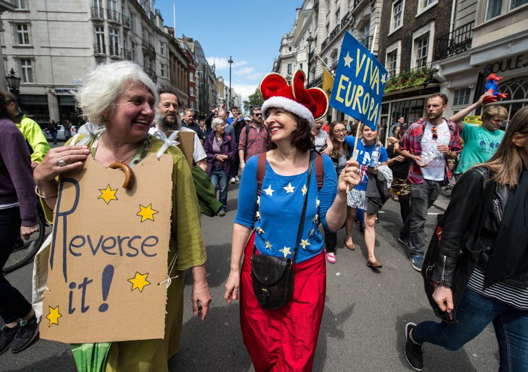 A woman wears a European flag top as thousands of protesters take part in a March for Europe, through the centre of London on July 2, 2016, to protest against Britain's vote to leave the EU, which has plunged the government into political turmoil and left the country deeply polarised. Protesters from a variety of movements march from Park Lane to Parliament Square to show solidarity with those looking to create a more positive, inclusive kinder Britain in Europe. / AFP PHOTO / CHRIS J RATCLIFFE