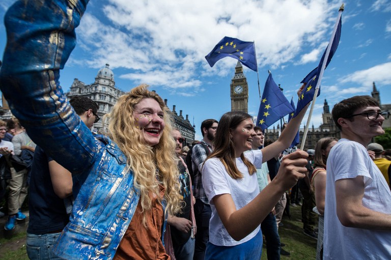 European flags are waved as thousands of protesters gather in Parliament Square as they take part in a March for Europe, through the centre of London on July 2, 2016, to protest against Britain's vote to leave the EU, which has plunged the government into political turmoil and left the country deeply polarised. Protesters from a variety of movements march from Park Lane to Parliament Square to show solidarity with those looking to create a more positive, inclusive kinder Britain in Europe. / AFP PHOTO / CHRIS J RATCLIFFE