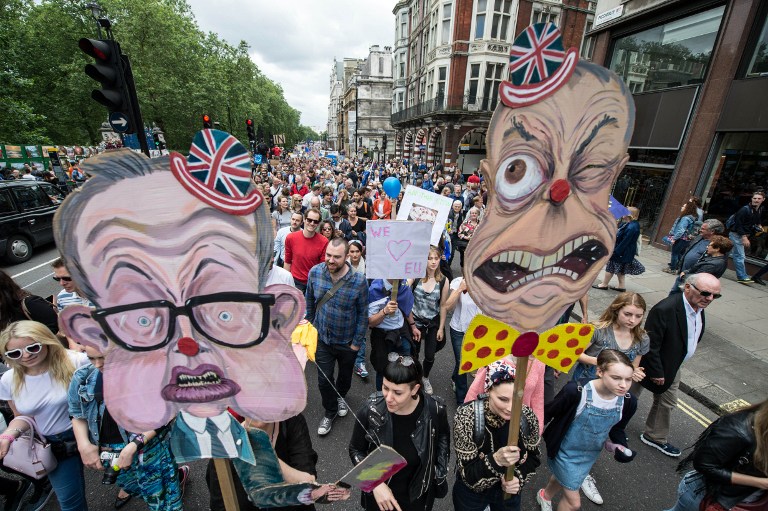 People hold up caricatures of Michael Gove and Nigel Farage as thousands of protesters take part in a March for Europe, through the centre of London on July 2, 2016, to protest against Britain's vote to leave the EU, which has plunged the government into political turmoil and left the country deeply polarised. Protesters from a variety of movements march from Park Lane to Parliament Square to show solidarity with those looking to create a more positive, inclusive kinder Britain in Europe. / AFP PHOTO / CHRIS J RATCLIFFE