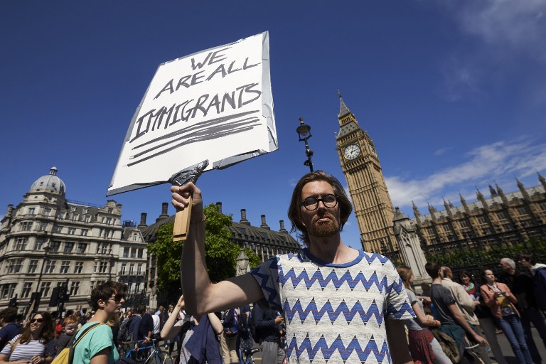 A man holds up a pro-Europe placard in Parliament Square as thousands of protesters take part in a March for Europe, through the centre of London on July 2, 2016, to protest against Britain's vote to leave the EU, which has plunged the government into political turmoil and left the country deeply polarised. Protesters from a variety of movements march from Park Lane to Parliament Square to show solidarity with those looking to create a more positive, inclusive kinder Britain in Europe. / AFP PHOTO / Niklas HALLE'N