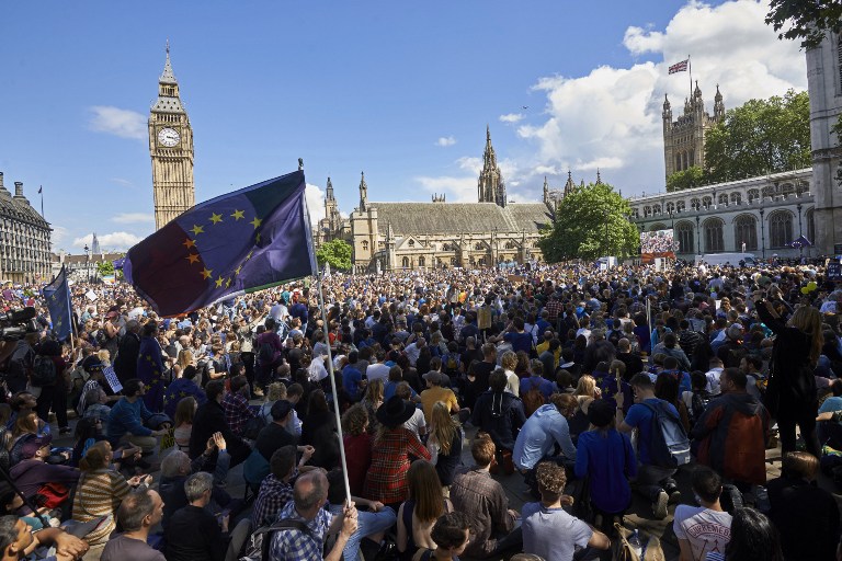 A European flag is flown as thousands of protesters gather in Parliament Square as they take part in a March for Europe, through the centre of London on July 2, 2016, to protest against Britain's vote to leave the EU, which has plunged the government into political turmoil and left the country deeply polarised. Protesters from a variety of movements march from Park Lane to Parliament Square to show solidarity with those looking to create a more positive, inclusive kinder Britain in Europe. / AFP PHOTO / Niklas HALLE'N