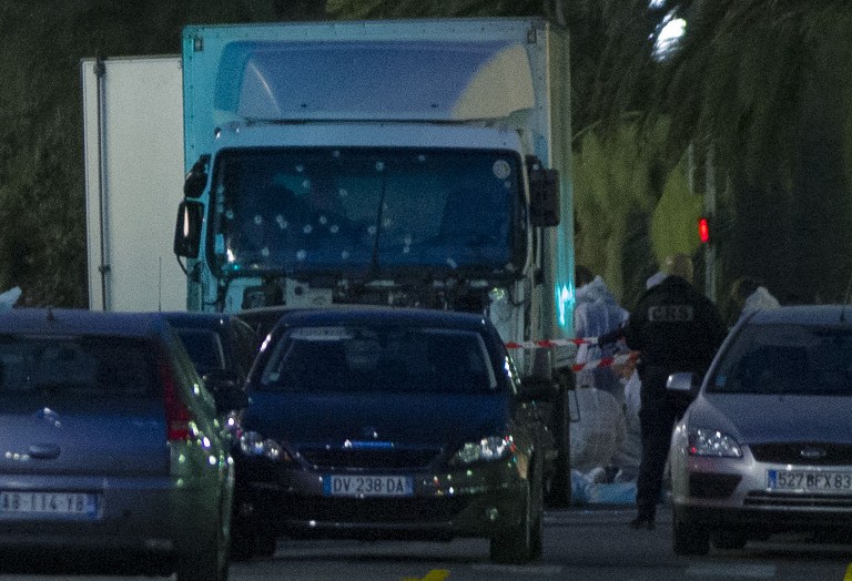 FRANCE, Nice: A truck with its windscreen riddled with bullets is seen on a street on July 15, 2016, after it ploughed into a crowd leaving a fireworks display in the French Riviera town of Nice. At least 84 people were killed when the truck ploughed into a crowd watching a Bastille Day fireworks display in the southern French resort of Nice, prosecutors said early on July 15. Nice prosecutor Jean-Michel Pretre said the truck drove two kilometres (1.3 miles) through a large crowd that was watching the fireworks. - Erick GARIN
