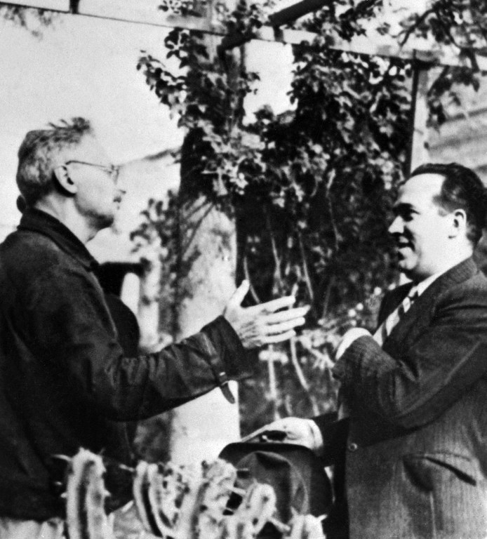 Picture taken 26 May 1940 in Mexico City showing the exiled Russian communist leader Leon Trotsky (L) talking with a reporter after an attempted assassination at his suburban Mexico City home. Leon Trotsky (1879-1940) was president of the St Petersburg Soviet in 1905, played a major role in the October Revolution and was commissar for war during the civil war (1917-1922). The founder of the Red Army was assassinated by Stalin's agent Ramon Mercader in Mexico 20 August 1940. / AFP PHOTO / ACME