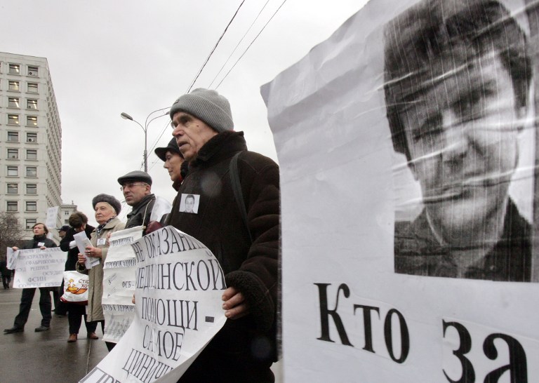 Russian human-rights activists hold portraits of former spy Alexander Litvinenko during their protest in front of the Russian Ministry of Internal Affairs in Moscow, 15 December 2006. Litvinenko, a fierce critic of President Vladimir Putin, fell ill 01 November 2006 in London, and died about three weeks later with large quantities of the radioactive substance polonium-210 found in his body. AFP PHOTO / DENIS SINYAKOV / AFP PHOTO / DENIS SINYAKOV