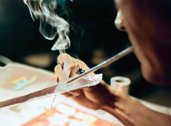 A drug user identified only as George uses a "tooter" to inhale smoke from melting metamphetamine hydrochloride, locally known as "shabu" or "ice" from a strip of an aluminum foil heated underneath with a tiny burning wick of paper 01 August. President Fidel Ramos has launched an all-out war against illegal drugs particularly against shabu which has alarmingly spread all over the country. Mr. Ramos call the phenomenal growth of narcotics trade in the country as a "national security threat." / AFP PHOTO