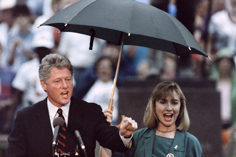 Democratic Presidential candidate Bill Clinton speaks while his wife Hillary holds an umbrella on September 7, 1992 during a campaign stop in Independence, President Harry S. Truman's hometown. / AFP PHOTO / Paul J. Richards