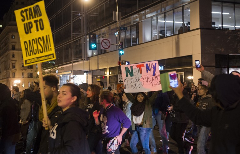 Protesters march through the streets during a demonstration near the White House after Donald Trump was elected as the next president of the US in Washington on November 9, 2016. Thousands of protesters rallied across the United States on November 9, expressing shock and anger over Donald Trump's election, vowing to oppose divisive views they say helped the Republican billionaire win the presidency. / AFP PHOTO / Andrew CABALLERO-REYNOLDS
