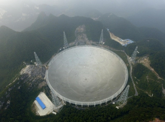 The Five-hundred-metre Aperture Spherical Radio Telescope (FAST) is seen on its first day of operation in Pingtang, in southwestern China's Guizhou province on September 25, 2016. The world's largest radio telescope began operating in southwestern China on September 25, a project which Beijing says will help humanity search for alien life. / AFP PHOTO / STR / China OUT
