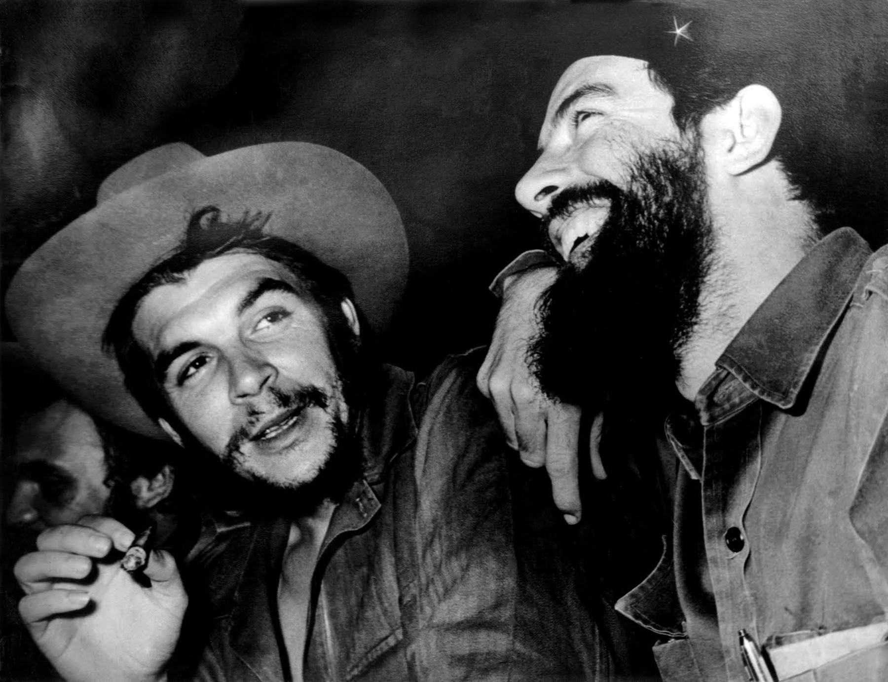 Cuba: Che  Guevara (centre) talks with Camilo Cienfuegos (right), Fidel Castro just visible to left